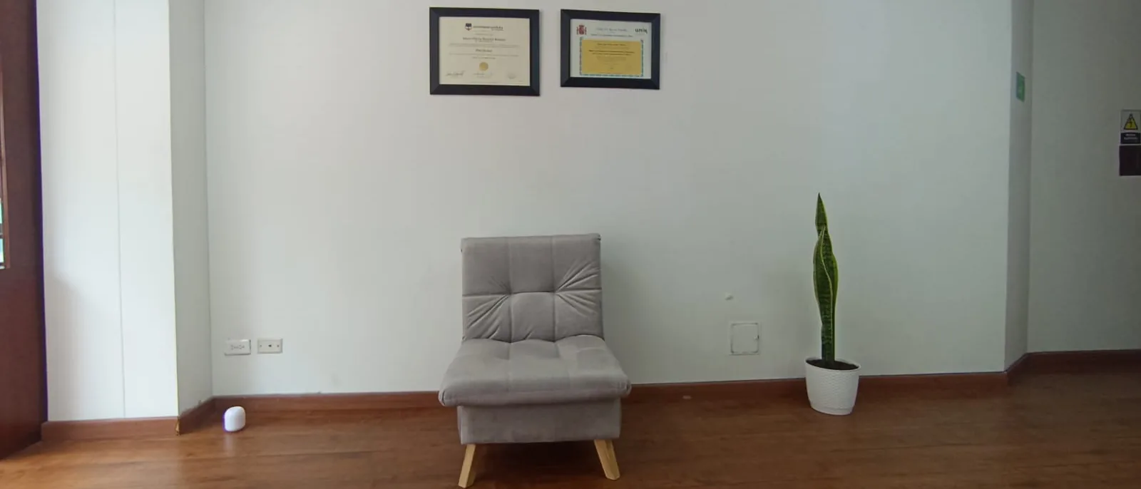 Consultorio de Ligia Parales en Bogotá: sillón de terapia y títulos universitarios enmarcados